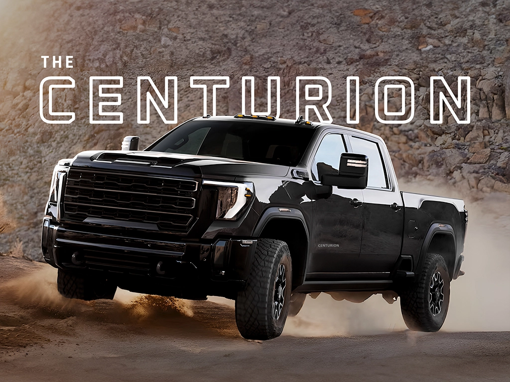 Black pickup truck, "The Centurion," on rocky terrain.