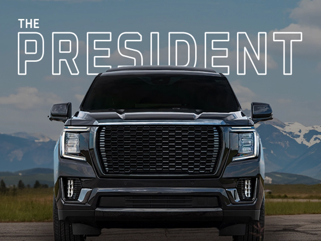 Black SUV named 'The President' with mountain backdrop.