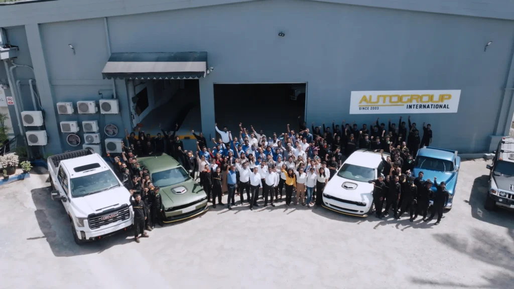 the staff from autogroup international standing in front of factory