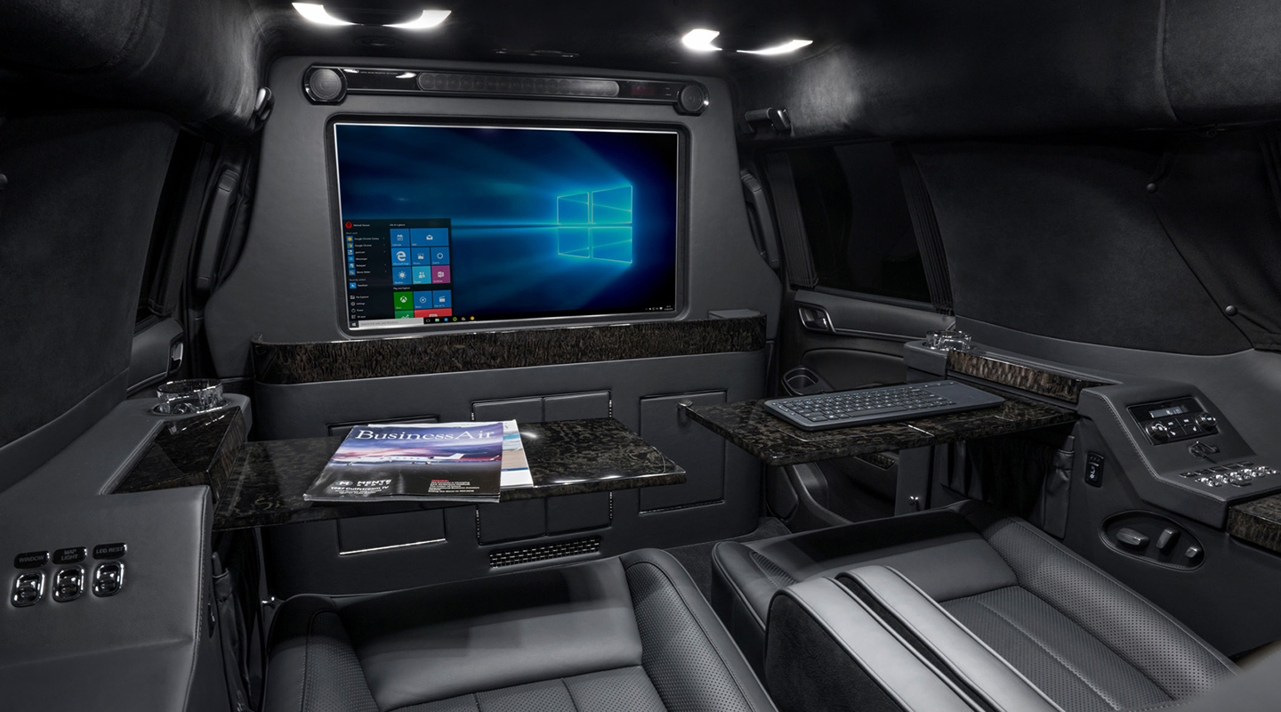 Luxurious vehicle interior with modern technology and comfortable seating.