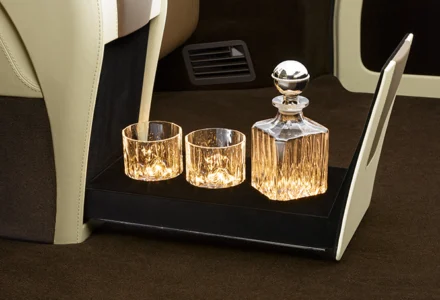 Luxury car decanter and glasses on tray.