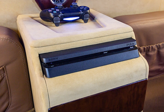 Sony PS4 and controller on living room chair.