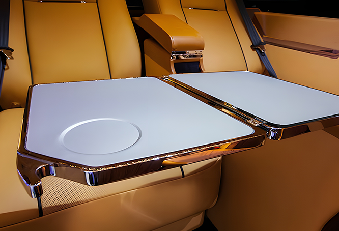 Luxurious car interior with foldable glossy tables.