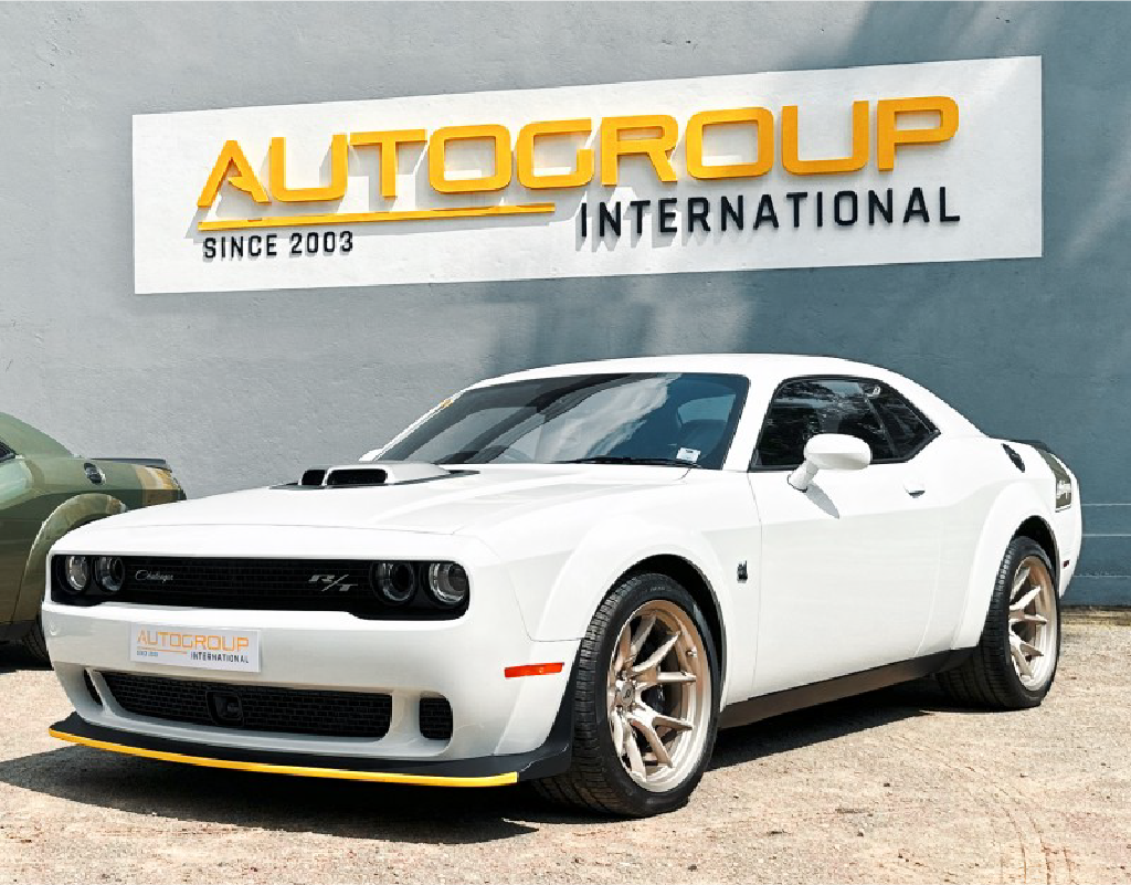 White Dodge Challenger at Autogroup International dealership.