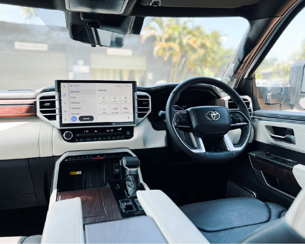 Modern Toyota SUV interior, dashboard and steering wheel.