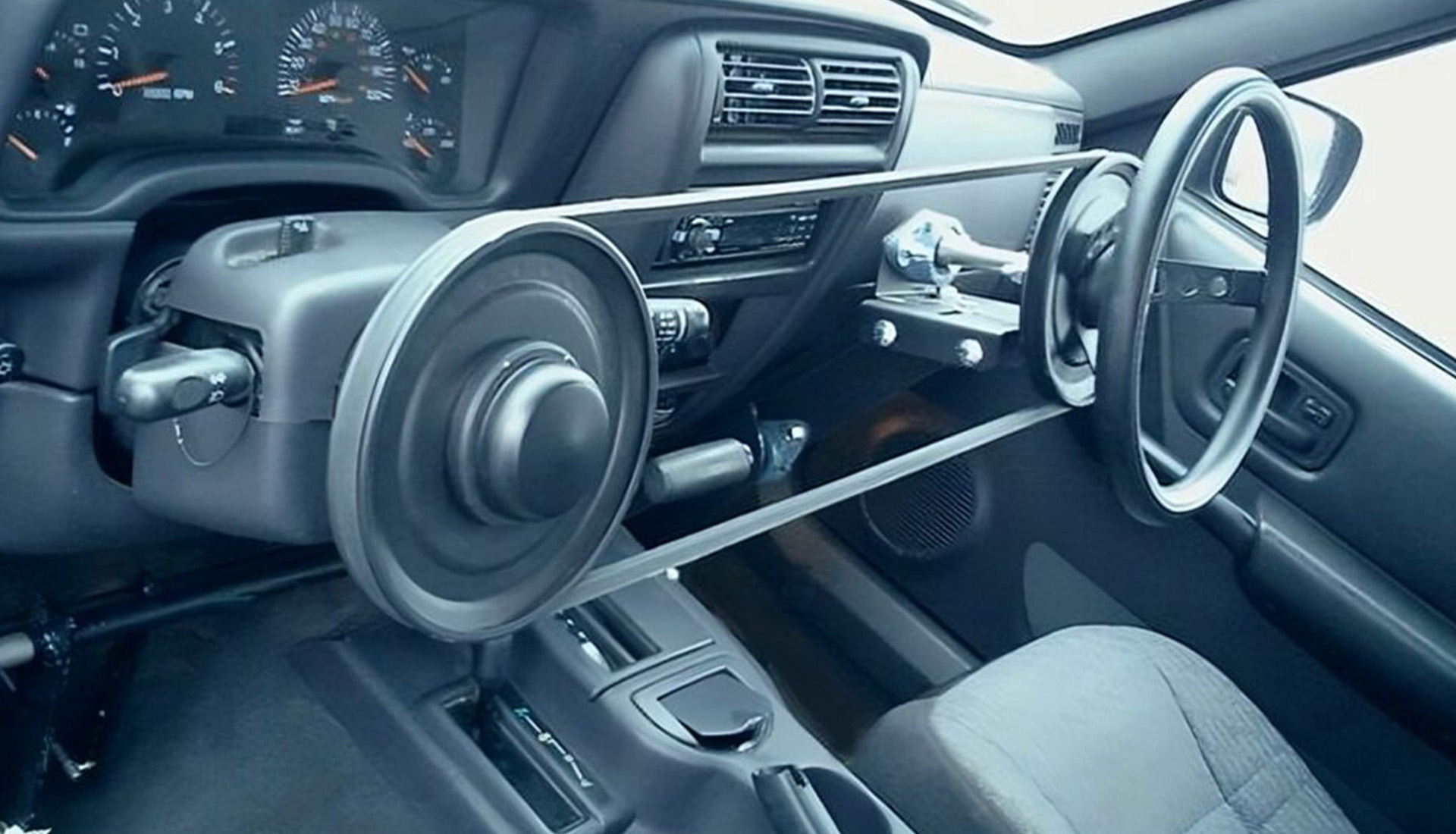 Modern car interior with steering wheel and dashboard.