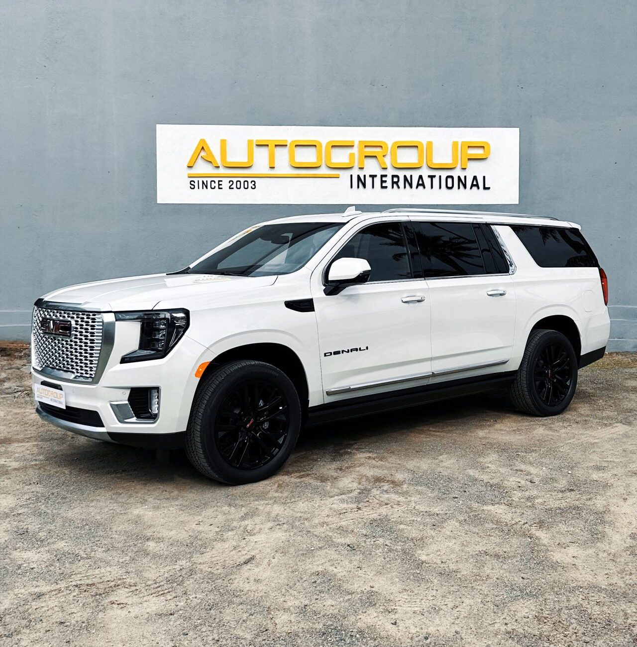 White Denali SUV at Autogroup International dealership.