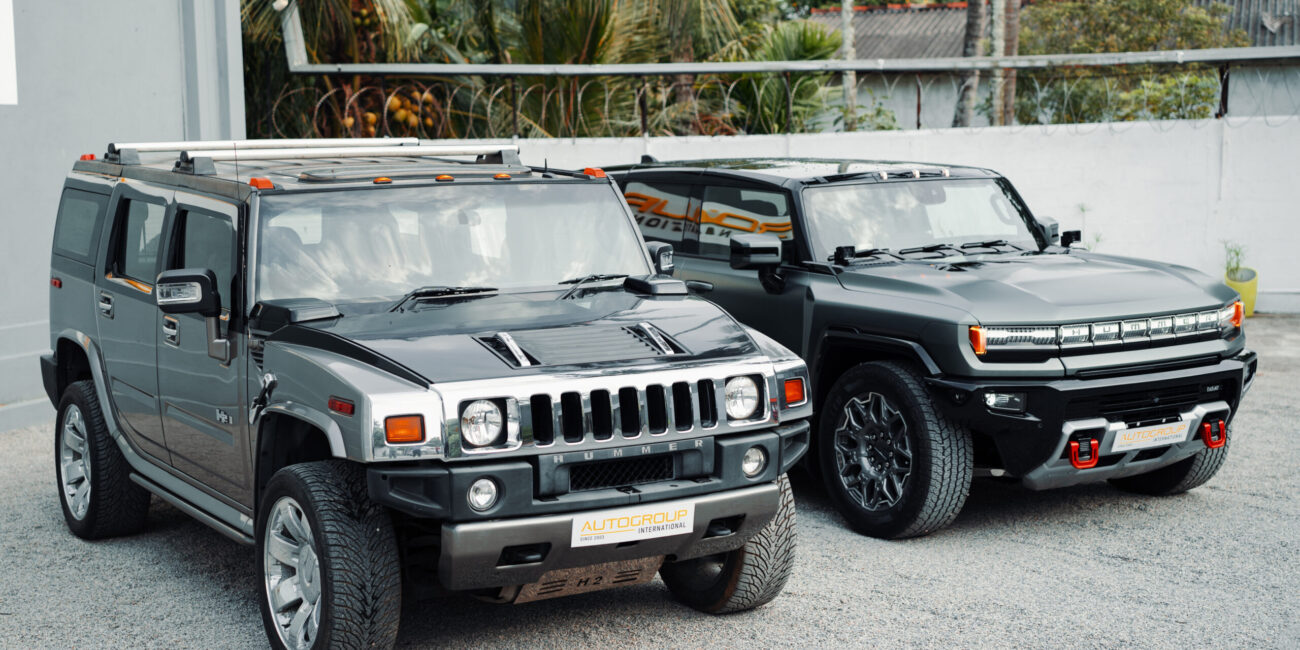 Hummer H2 and electric Hummer EV in tropical setting.