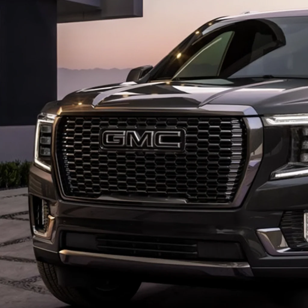Close-up of GMC truck grille at dusk.
