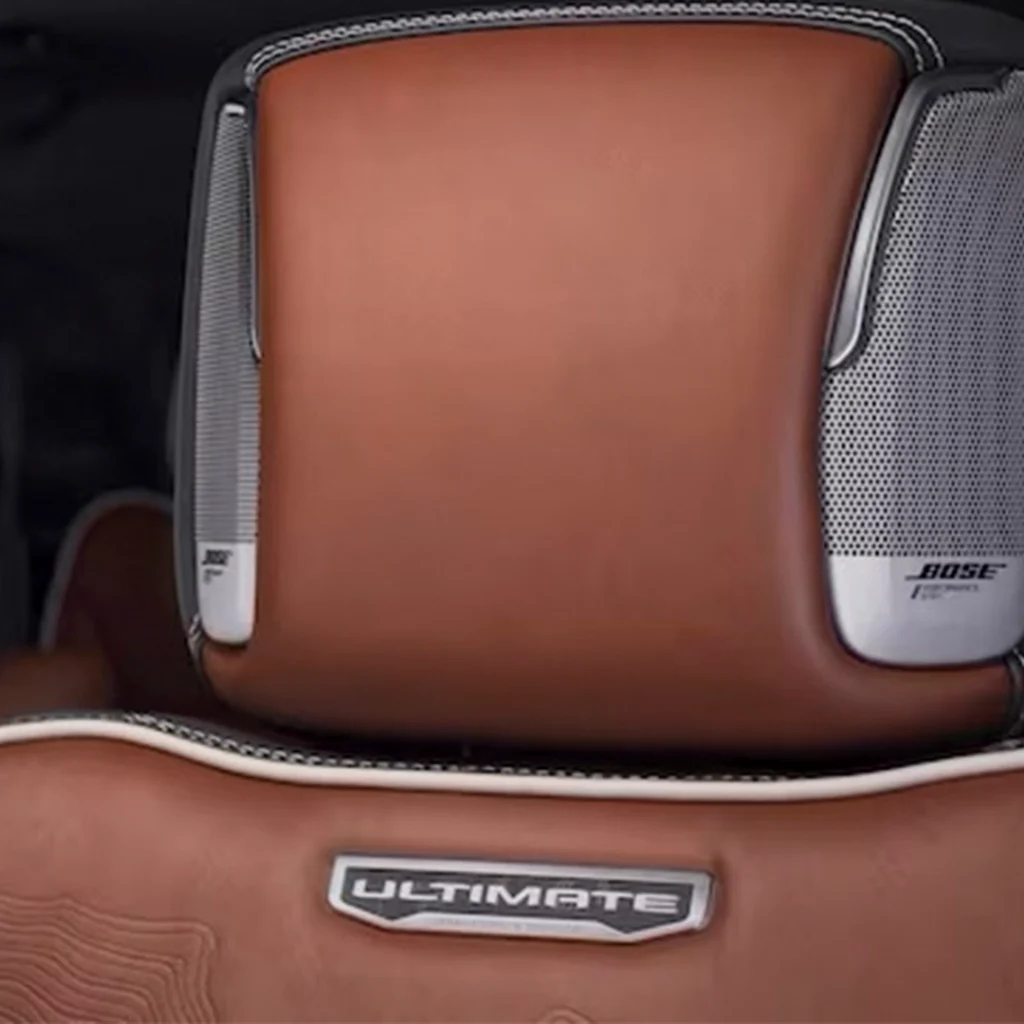 Close-up of luxury car seat with Bose speakers.