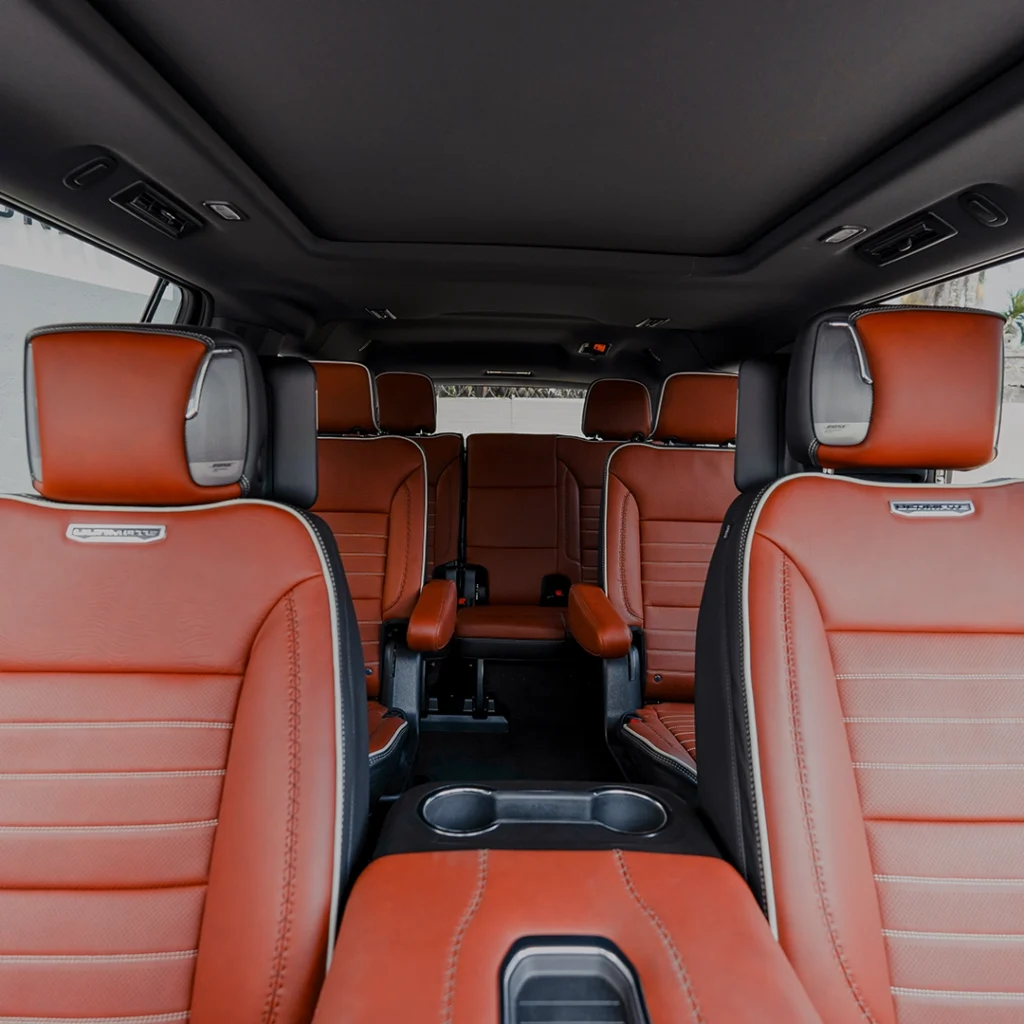 Luxurious SUV interior with spacious red leather seats.