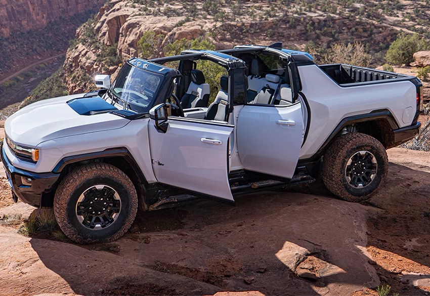 White hummer ex pickup truck on rocky desert terrain with moonroof infinity panels removed