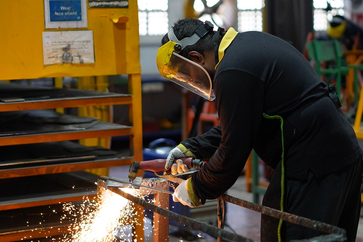 man welding at Autogroup International production facility.