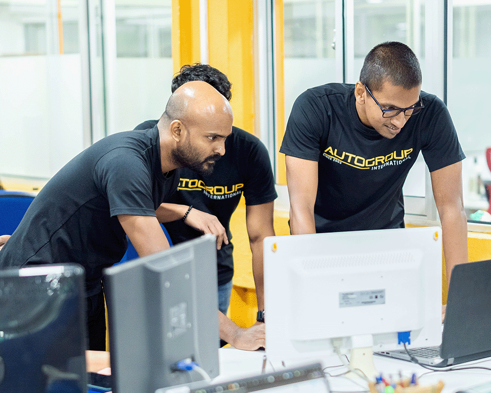 three engineers near a computer