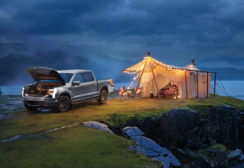 camping outdoors using ford f-150 lightning ev as power source