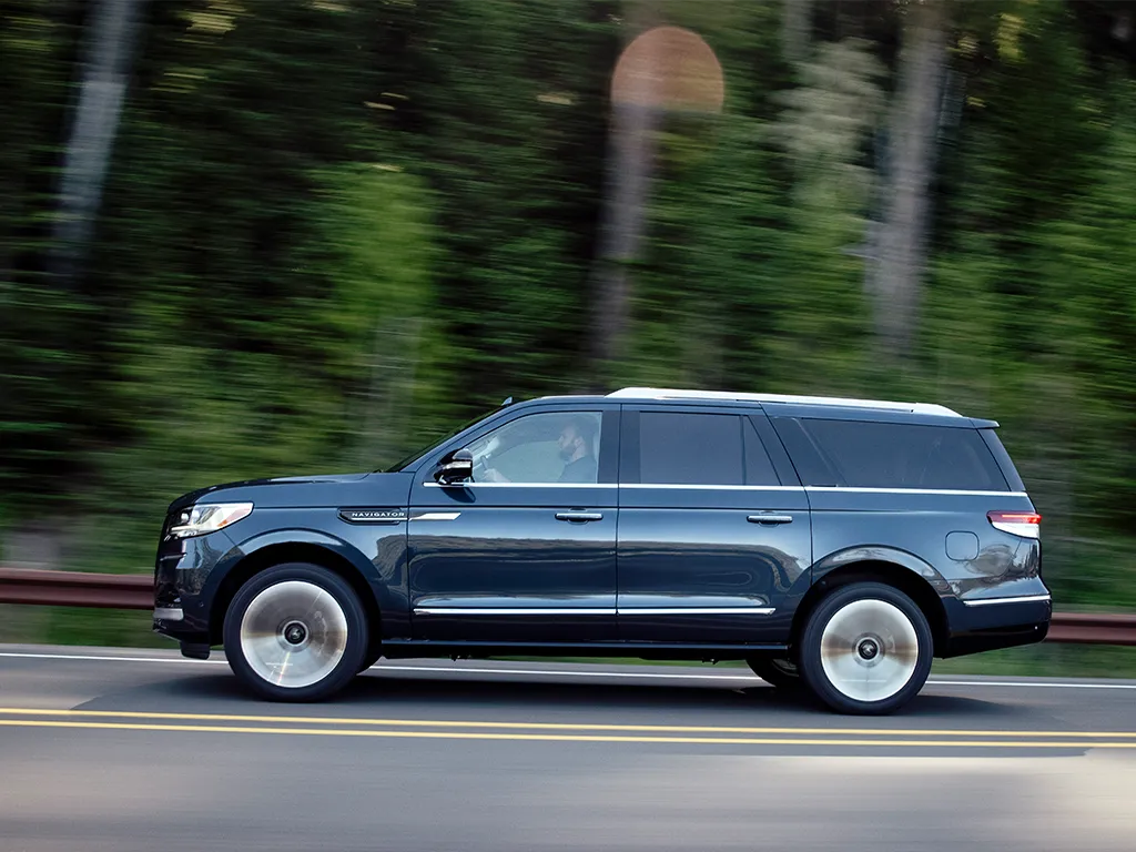 lincoln navigator black label speeding along road