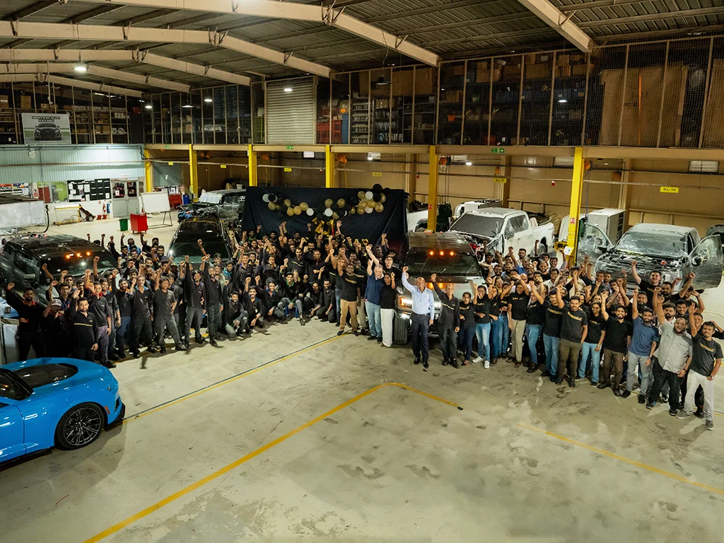 the autogroup international staff celebrating in automotive workshop