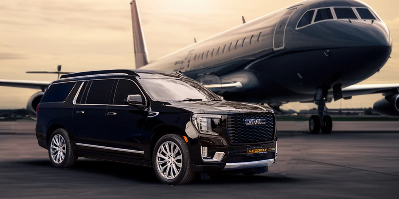 Luxury SUV near private jet on runway at dusk