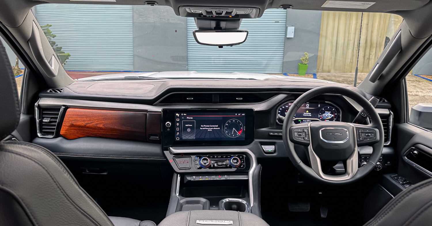 Modern car interior with digital displays and wood accents