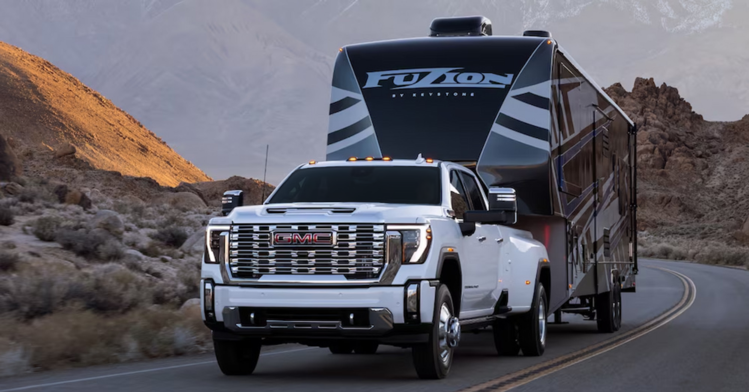 GMC truck towing large Fusion Keystone RV on road