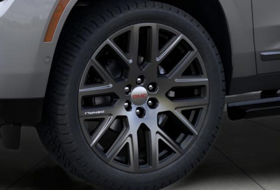 The 2025 GMC Yukon XL Denali Ultimate in Sterling Metallic by Autogroup International (wheels) in right-hand drive