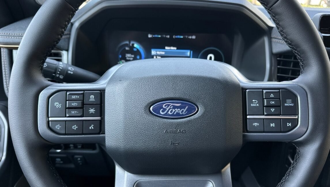 Right-hand drive 2025 Ford F-150 Lightning Lariat in Star White Metallic Tri-Coat from Autogroup International. Extended Range 131 kWh, up to 515 km.
