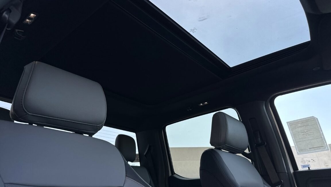 Right-hand drive 2025 Ford F-150 Lightning Lariat in Star White Metallic Tri-Coat from Autogroup International. Extended Range 131 kWh, up to 515 km.