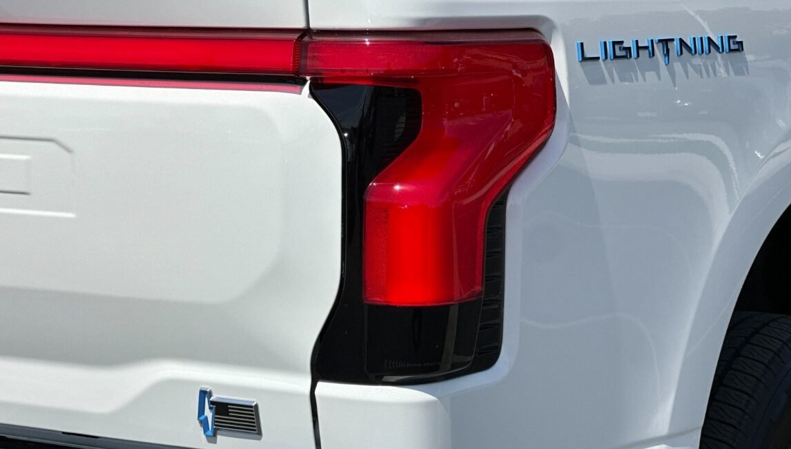 Right-hand drive 2025 Ford F-150 Lightning Lariat in Star White Metallic Tri-Coat from Autogroup International. Extended Range 131 kWh, up to 515 km.