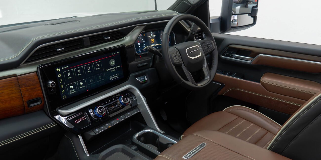 ight-hand drive 2025 GMC Sierra 3500 Denali Ultimate DRW in Summit White, Alpine Umber. 6.6L Duramax, Allison 10-speed, luxury heavy-duty capability from Autogroup International