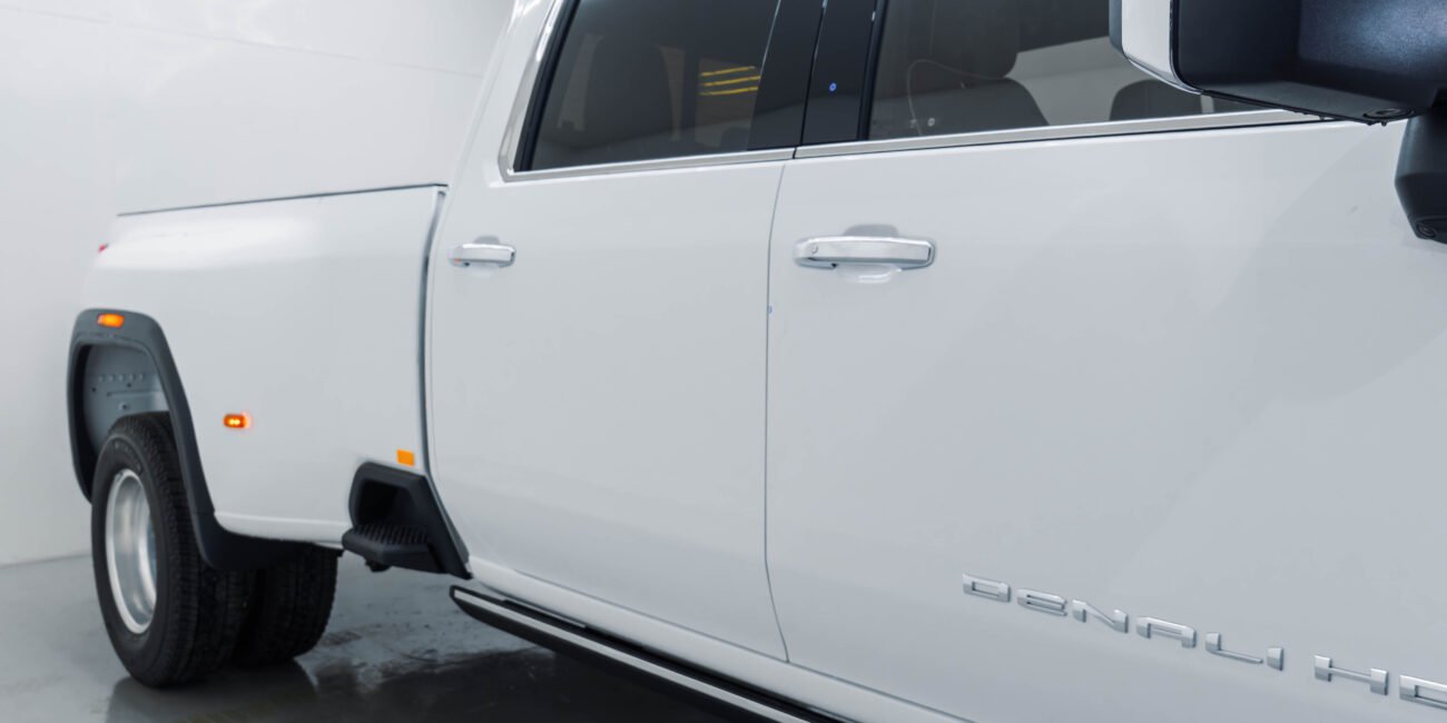 ight-hand drive 2025 GMC Sierra 3500 Denali Ultimate DRW in Summit White, Alpine Umber. 6.6L Duramax, Allison 10-speed, luxury heavy-duty capability from Autogroup International