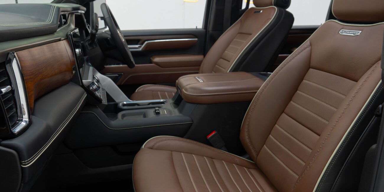 ight-hand drive 2025 GMC Sierra 3500 Denali Ultimate DRW in Summit White, Alpine Umber. 6.6L Duramax, Allison 10-speed, luxury heavy-duty capability from Autogroup International