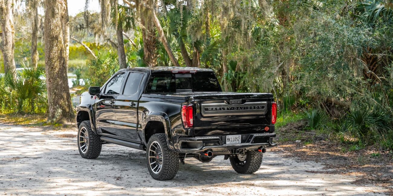 Black Harley-Davidson pickup truck parked in forest