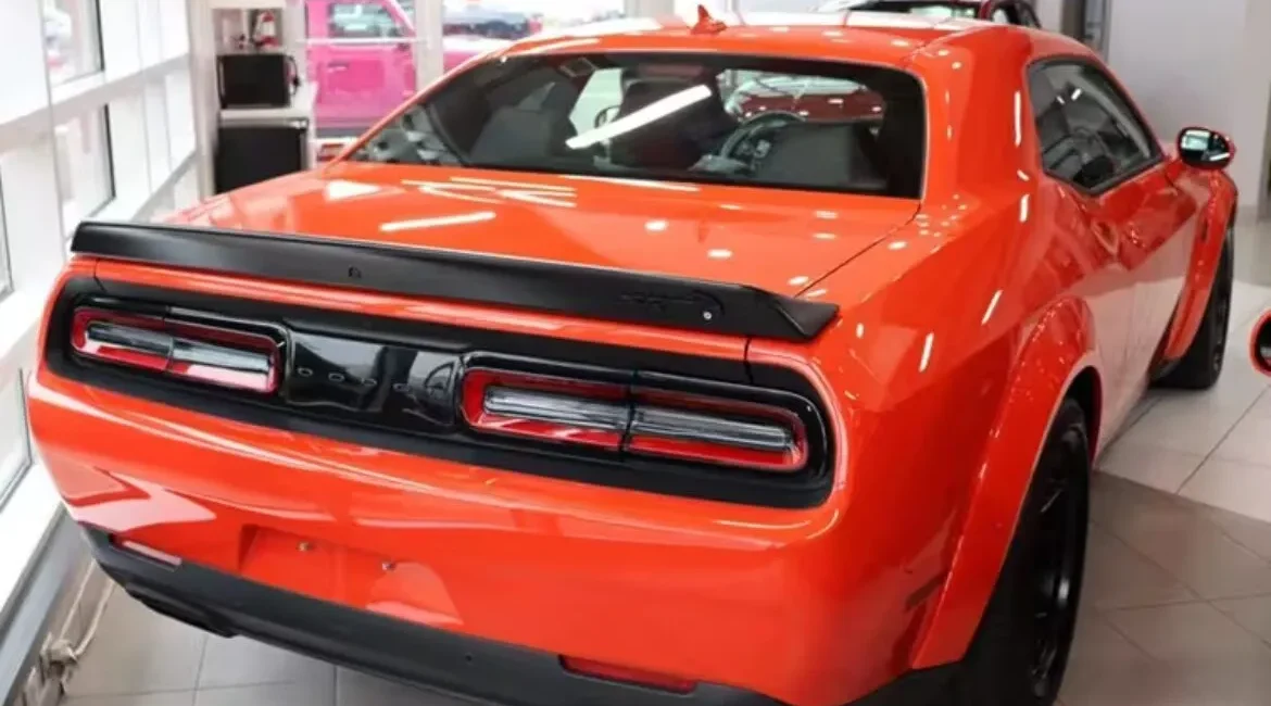 Orange sports car in showroom