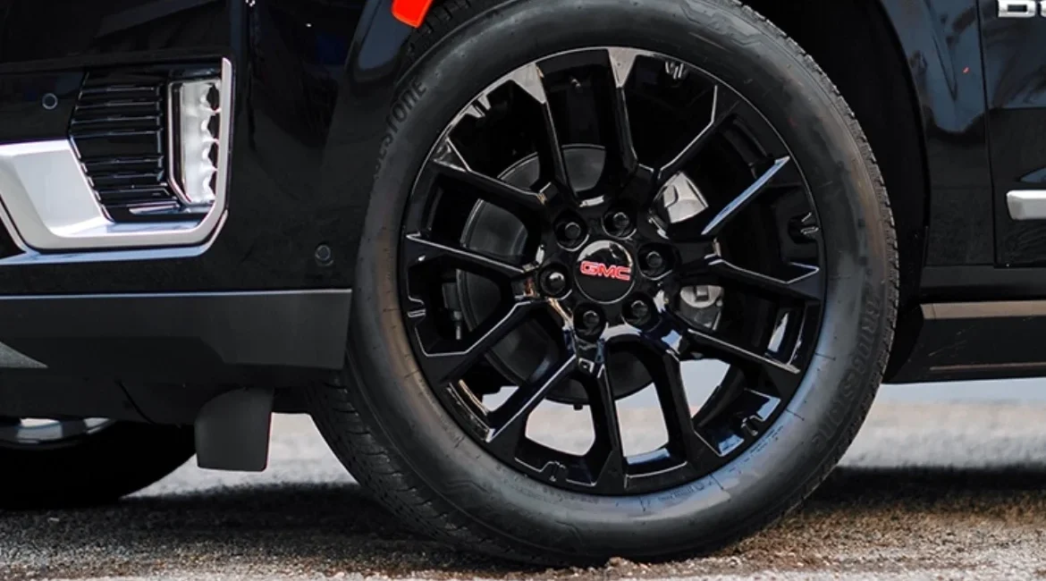 Black GMC alloy wheel and tire close-up