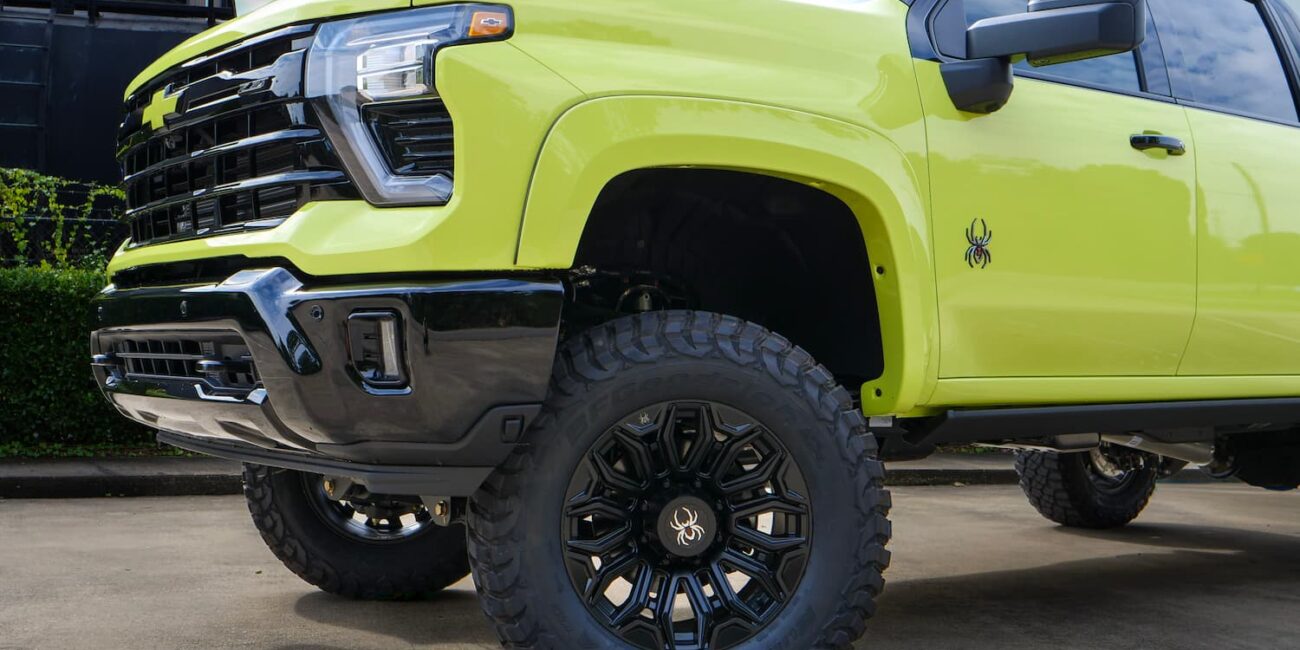 Lime green lifted Chevy truck with black wheels