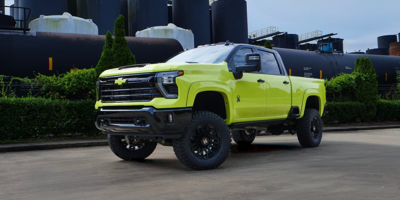 Bright yellow lifted Chevrolet truck parked outdoors