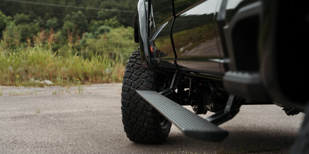 Close-up of truck tire and side step