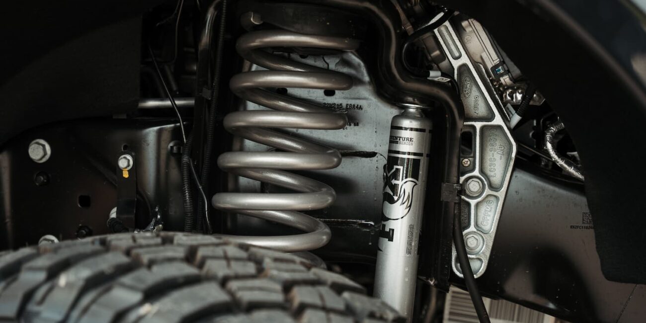 Closeup of truck suspension system with coil spring