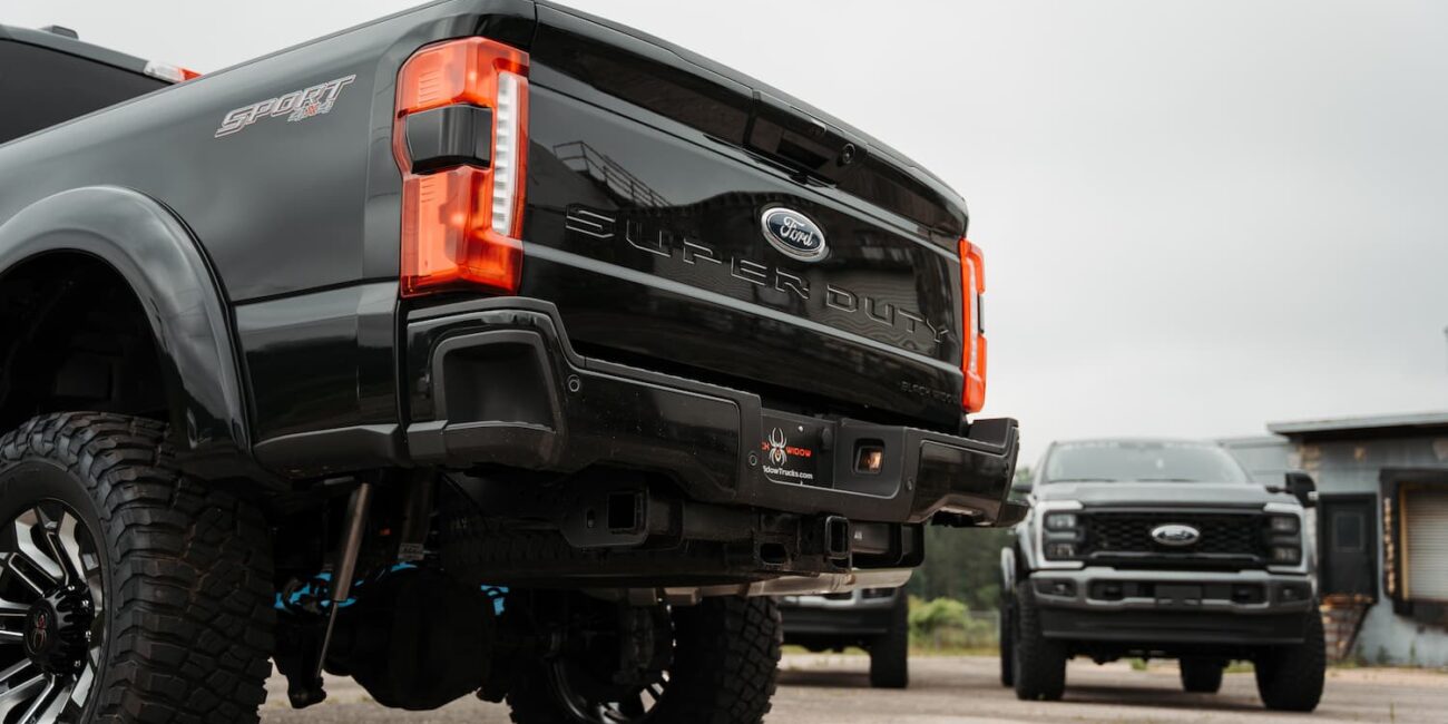 Black Ford Super Duty trucks parked outdoors