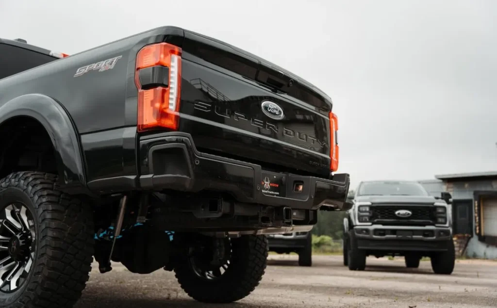 Black Ford Super Duty trucks parked outdoors