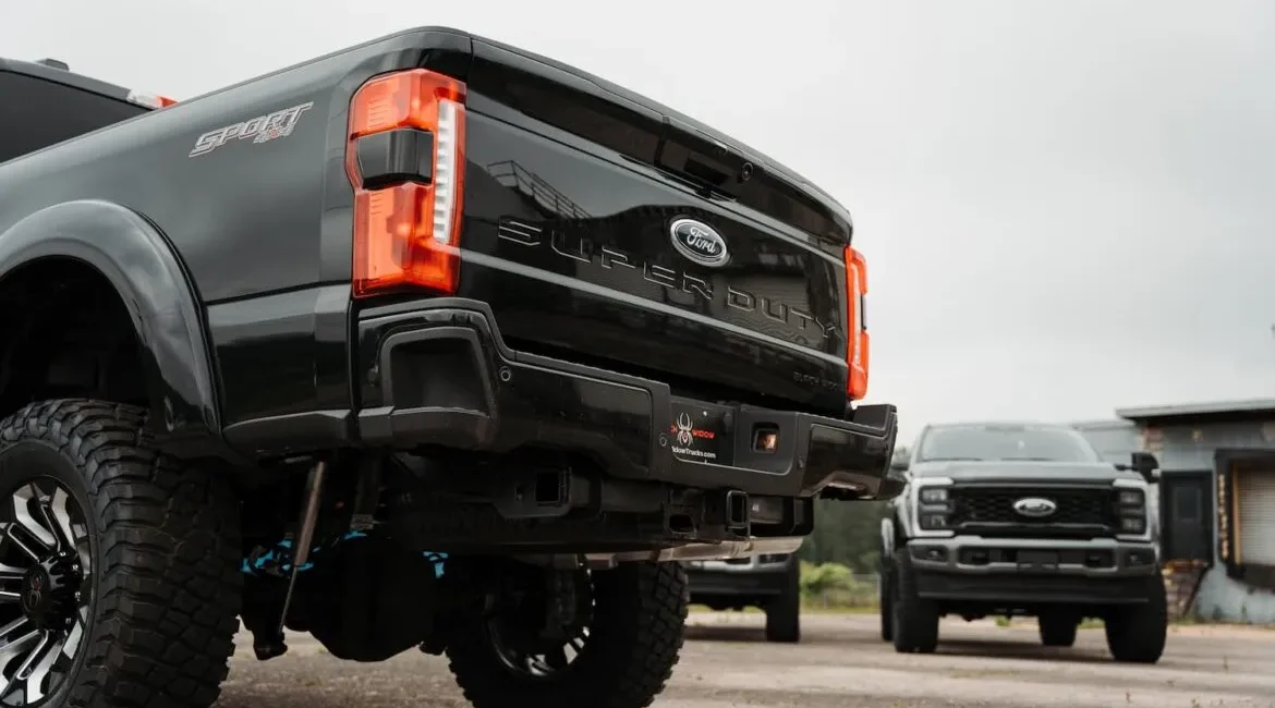 Black Ford Super Duty trucks parked outdoors