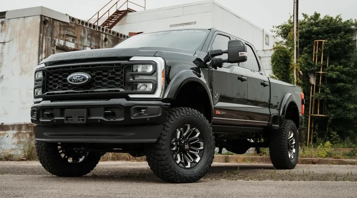 Black lifted Ford Super Duty truck outdoors