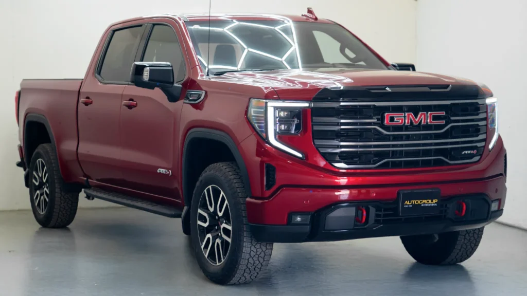 Red GMC pickup truck in showroom