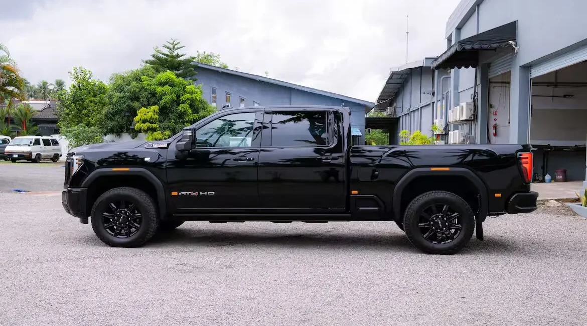 Black pickup truck parked outside industrial building