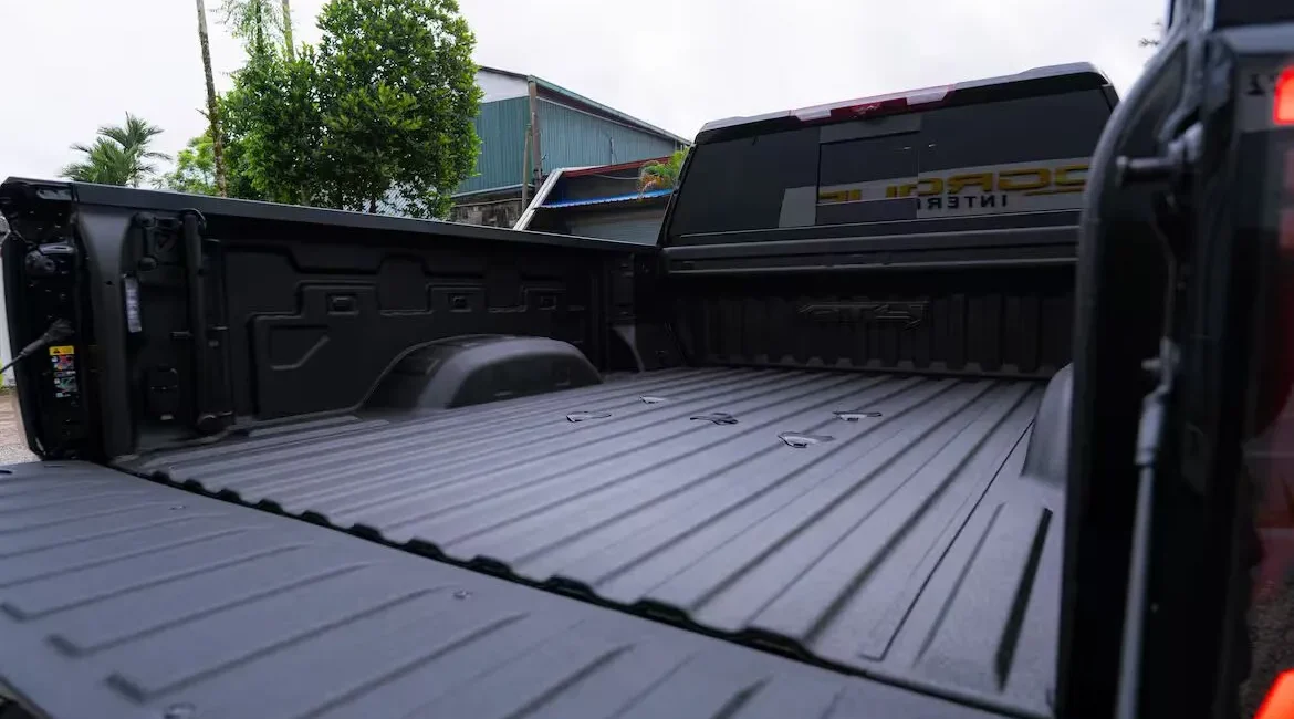 Empty black pickup truck bed outdoors