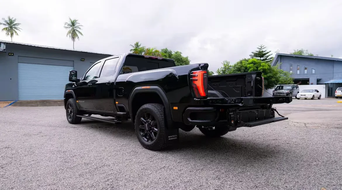 Black pickup truck with open tailgate outdoors