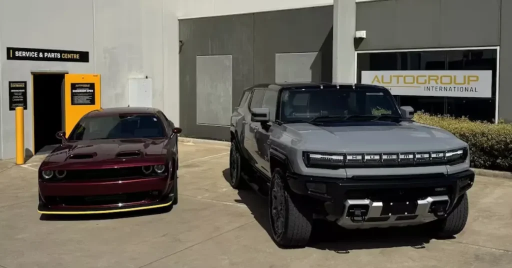Two parked cars outside Autogroup International building