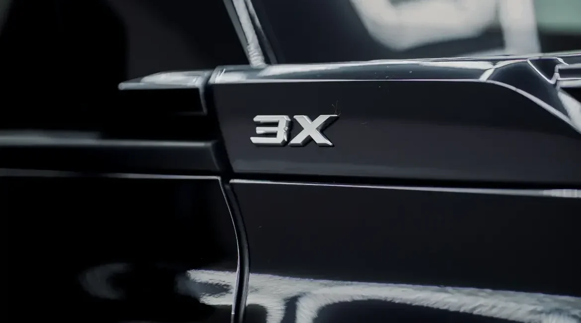 Close-up of car with 3X badge