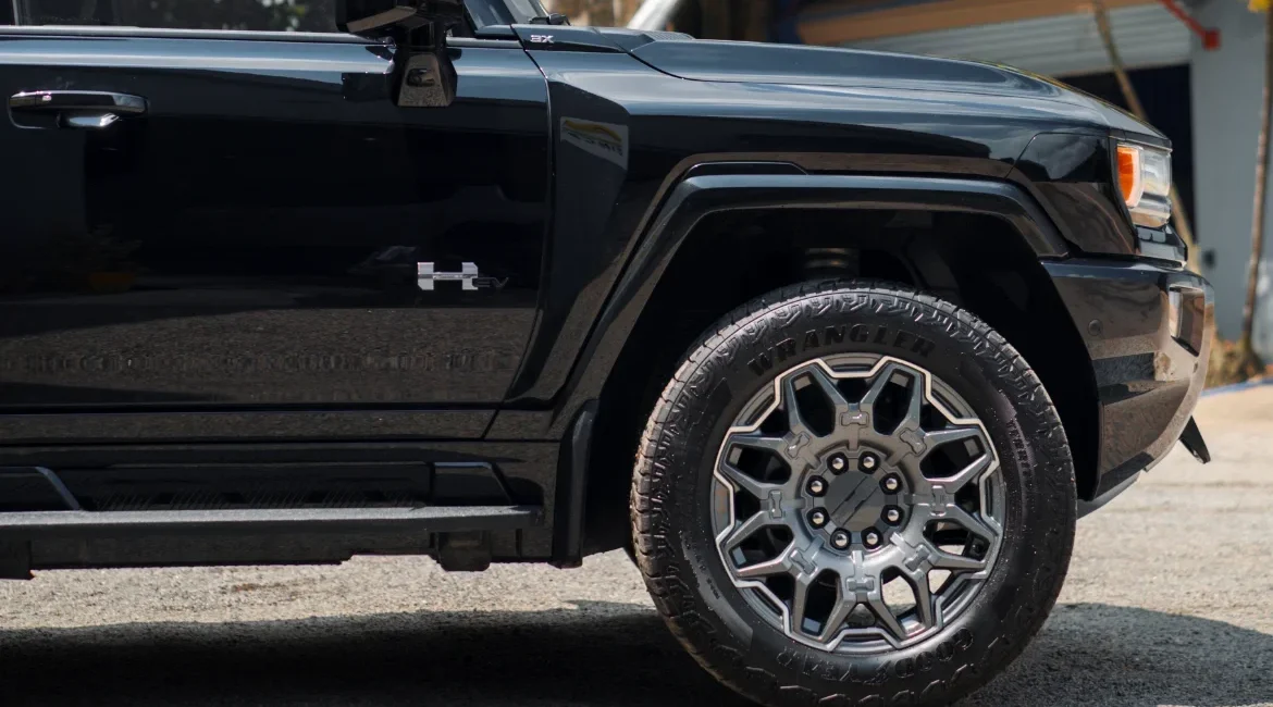 Close-up of black electric truck front wheel