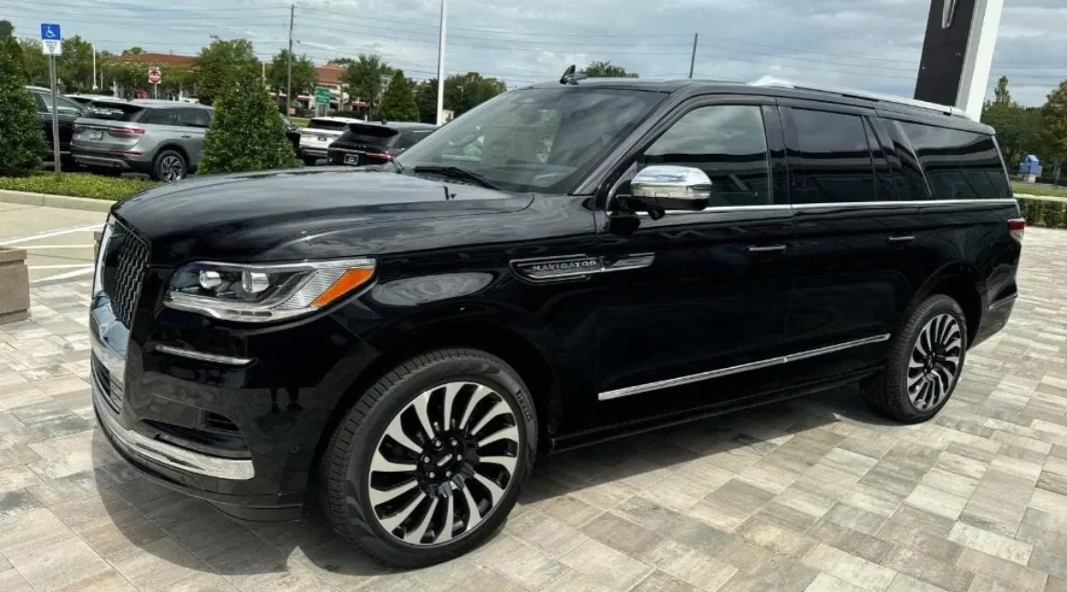 Black luxury SUV parked at dealership